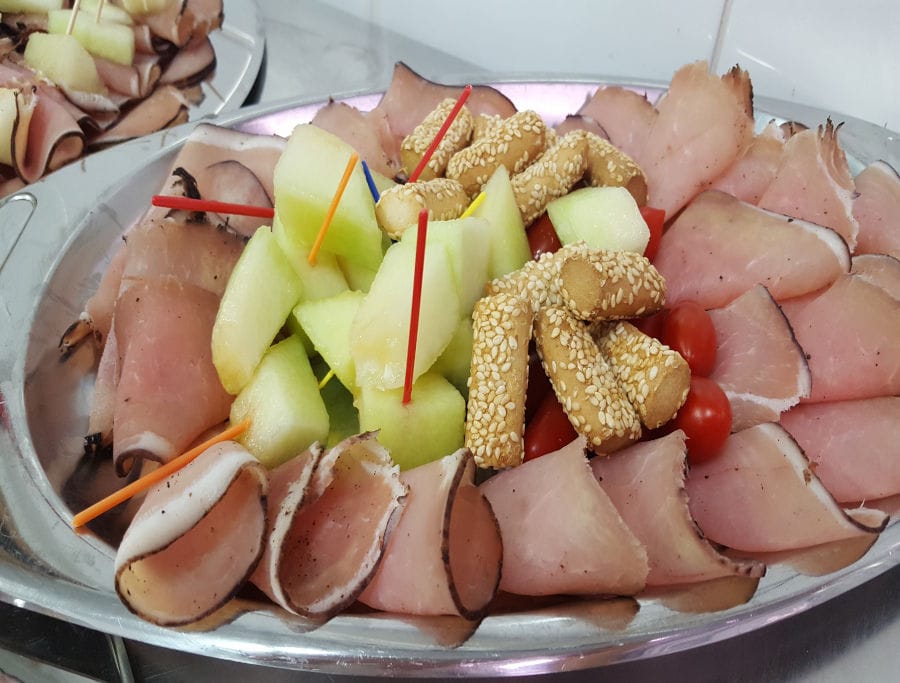 plateau with louza, tomato cherries, melon,breadsticks and colourful toothpicks at 'Roussounelos Meat Market'
